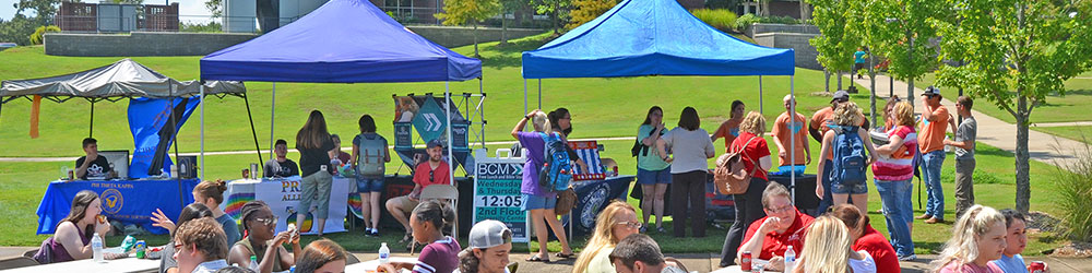 Student organization tents set up at a an on-campus event.