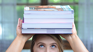 Student balancing books on her head.