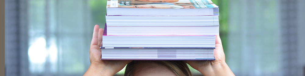 Student balancing books on her head.